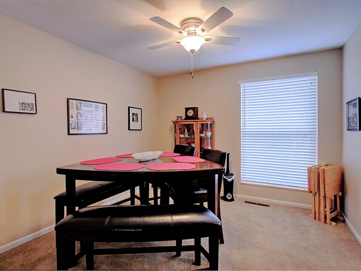 Image of dining room with table, chairs, and ceiling fan